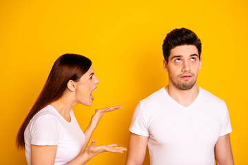 Close up side profile photo beautiful she her he him his guy lady pair blaming yell its your fault aggression awful situation round roll eyes up wear casual white t-shirts isolated yellow background