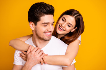 Close-up portrait of his he her she two nice cute lovely charming attractive cheerful cheery positive people cuddling isolated over vivid shine bright yellow background