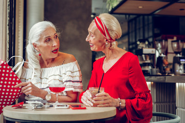 Joyful aged women meeting in the restaurant
