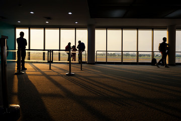 Fototapeta premium Silhouette tourist at airtport terminal at sunrise