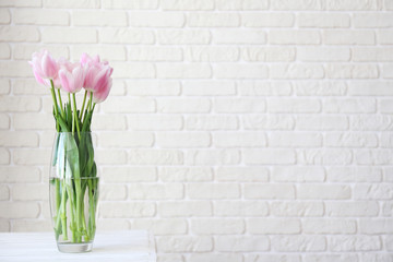 Multy purpose fresh flower composition, bouquet of tulips w/ open pink buds in glass vase. Women's day, mother's day greeting concept. Copy space, close up, top view, crop shot, background.
