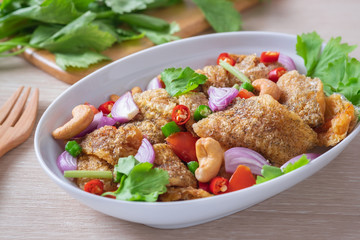 Spicy crispy gourami fish salad on plate, Thai food.