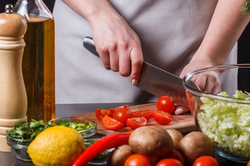 young woman in a gray apron cherry tomatoes