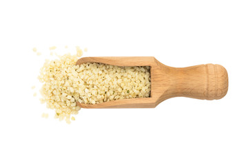 Shelled or peeled hemp seeds on a wooden spoon or scoop seen directly from above and isolated on white background