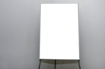 white flip chart in a conference room against a gray wall