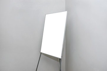 white flip chart in a conference room against a gray wall