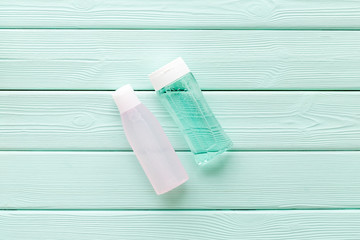 mycelial water, lotion for skin care on mint green wooden background flat lay space for text