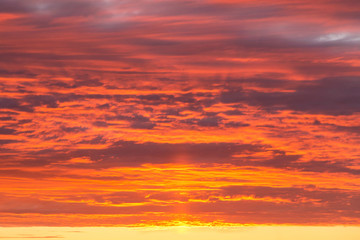 Epic dramatic sunset, sunrise orange sky with clouds and sunlight background texture
