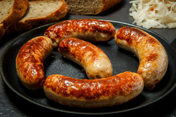 closeup tasty ruddy meat wieners fried in large frying pan