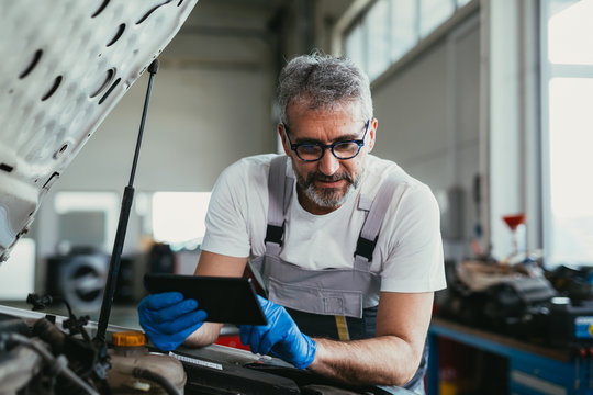 Mechanic Using Tablet In Car Service