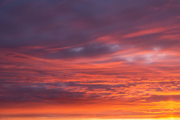 Naklejka na ściany i meble Dramatic epic sunset orange pink sky with clouds background texture