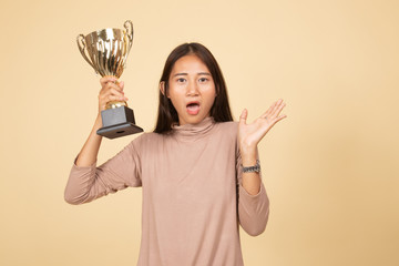 Successful young asian woman holding a trophy.