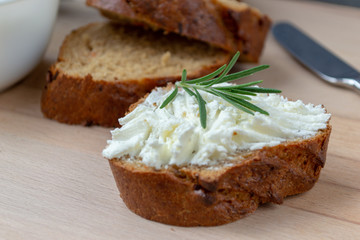 Fototapeta na wymiar Sliced bread with light cheese on a wooden board.