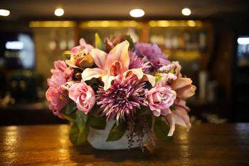 Modern cafe with a bar. A bouquet of flowers on the foreground