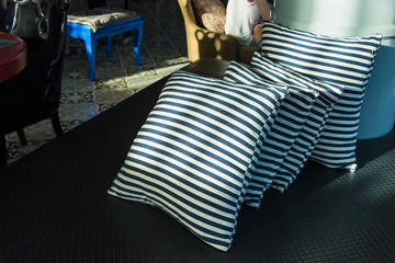 Detail of modern living room with beige pillow cushions on sofa.
