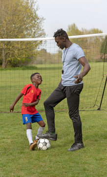 Hampshire, England UK. April 2019. Young soccer player being coached on a football pitch.