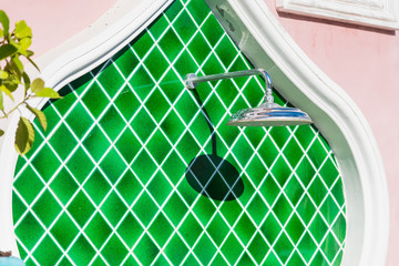 Outdoors shower beside Swimming pool.