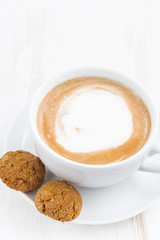 cup of cappuccino and flavored cookies, vertical