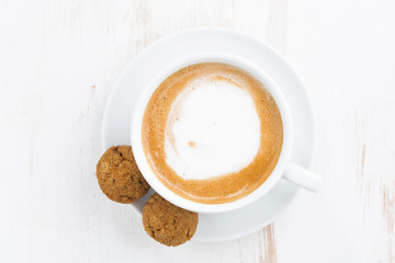 cup of cappuccino and flavored cookies, top view