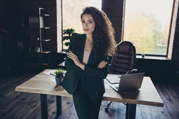 Portrait positive cheerful satisfied entrepreneur content stand desk table computer laptop netbook...