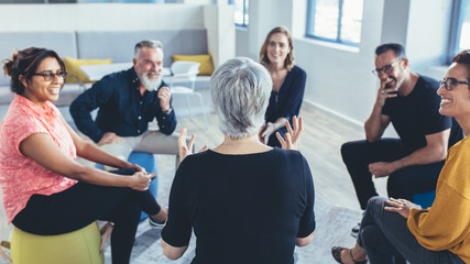 Business team sitting in circle and discussing