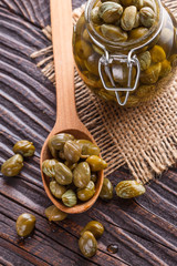 pickled capers on a wooden rustic background