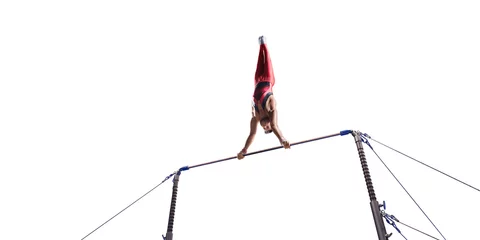 Fotobehang Gymnastiek Male athlete doing a complicated exciting trick on horizontal gymnastics bars on white background. Isolated Man perform stunt in bright sports clothes  © Alex