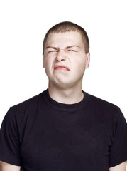 Fototapeta premium Portrait of young man. Facial expression. Disgust face.