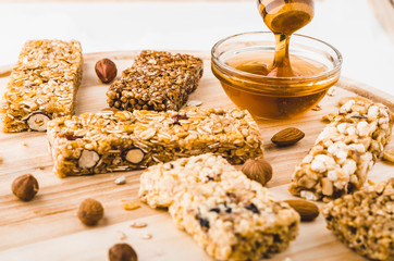 Museli, cereal, granola protein energy bars and honey