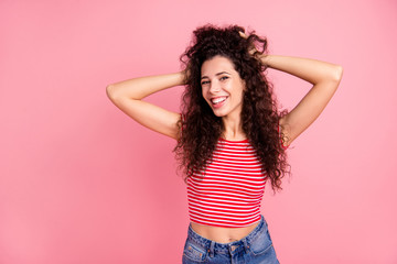 Portrait of her she nice-looking attractive lovely charming cute shine winsome sweet cheerful cheery wavy-haired girl having fun making coiffure isolated over pink pastel background
