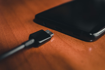 close up of black Smartphone charging