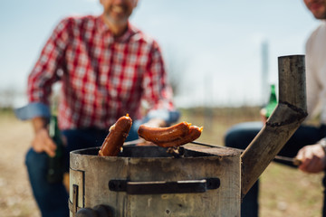 closeup of barbecuing sausages outdoor