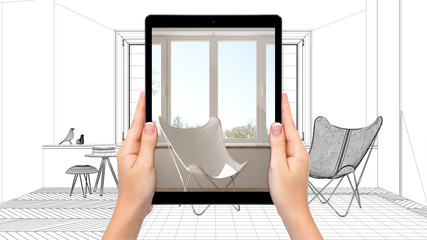 Hands holding tablet showing modern living room. Blueprint CAD sketch background, augmented reality concept, application to simulate furniture and interior design products