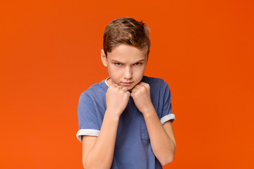 Teen boy clenching fists, ready to fight