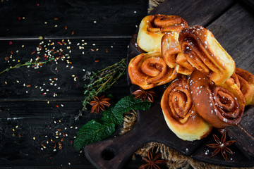 Sweet buns with cinnamon. Top view. Free space for your text. Rustic style.