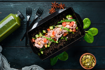 Quinoa with Tuna and Vegetables. Food with delivery. Top view. Free space for your text. Rustic style.