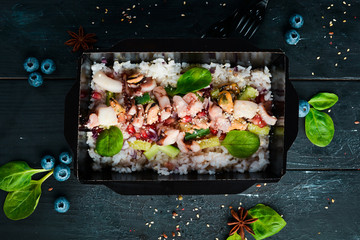 Rice with vegetables and seafood. Healthy food, restaurant dish delivery. Top view. Free space for your text.