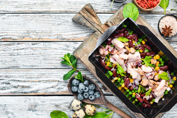 Seafood with corn, beans and green peas. Food with delivery. Top view. Free space for your text. Rustic style.