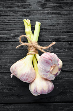 Fresh garlic on a wooden background. Top view. Free space for your text.