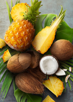 Fresh ripe coconut and pineaple on concrete