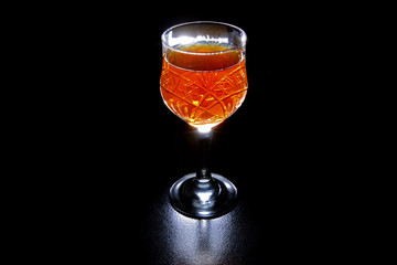 glass of red wine on black background