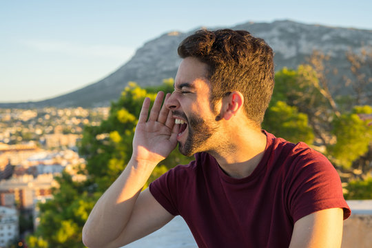 Young man shouthing aside in the countryside