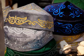 Traditional Asian headdresses from a multicolored felt with an embroidered colored thread of...