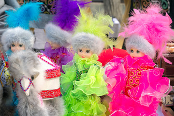 Dolls in bright multicolored women's national costumes of Kazakhstan. Close-up