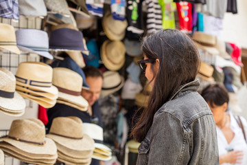 Fototapeta na wymiar young Indian woman buying hats