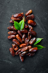 Dry date on a black background. Top view. Free space for your text.