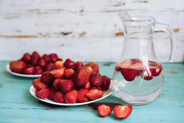Strawberries in the white plate on the white wooden background, strawberries on wooden table background,  top view