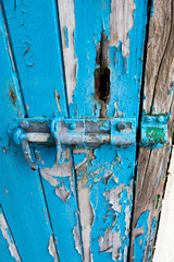 Door bolt with flaking paintwork on condemned derelict factory building awaiting demolition 