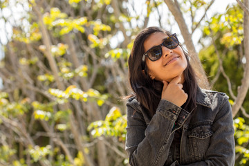 Young indian woman thinking and happy