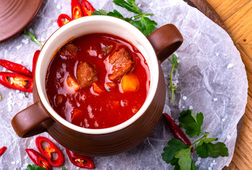 Goulash traditional homemade European beef meat stew soup, Hungarian bograch, close-up, on wooden...